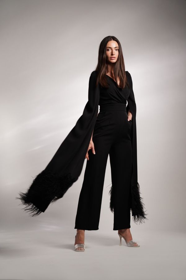 Black jumpsuit with feather cape sleeves