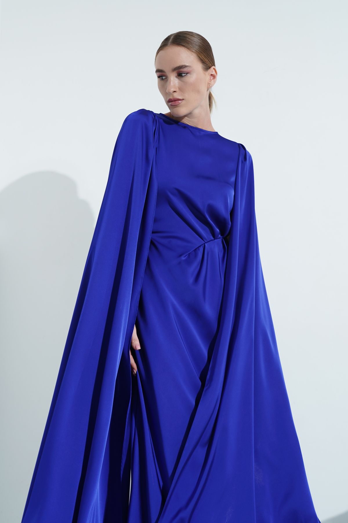 IMAGE CODE in Greyish Blue Halter Neck Cape Sleeves Gown – Sanya Gulati
